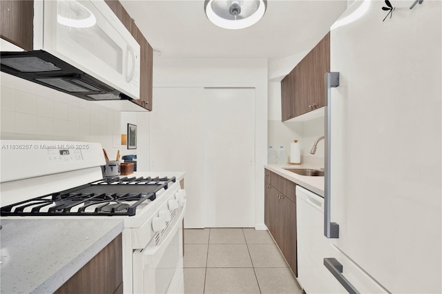 6886 N Kendall Dr Unit D102, Pinecrest, FL 33156 - kitchen featuring white appliances, decorative backsplash, and light tile patterned flooring