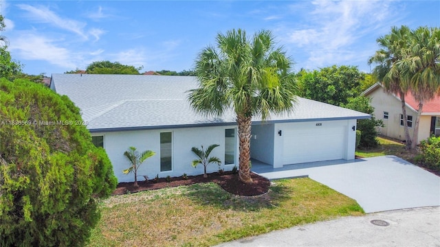 4808 Mango Dr, Tamarac, FL 33319 - view of front of home featuring an attached garage, driveway, stucco siding, roof with shingles, and a front yard