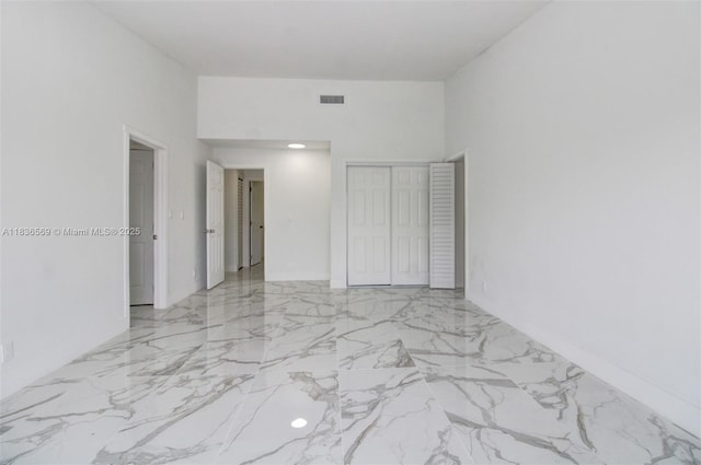 4808 Mango Dr, Tamarac, FL 33319 - unfurnished bedroom featuring light marble finish flooring and a closet