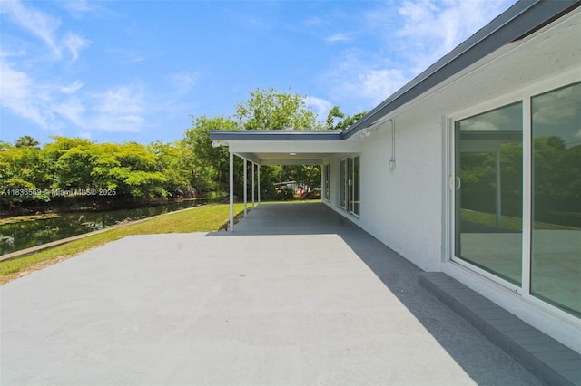 4808 Mango Dr, Tamarac, FL 33319 - view of patio / terrace with a water view and a carport