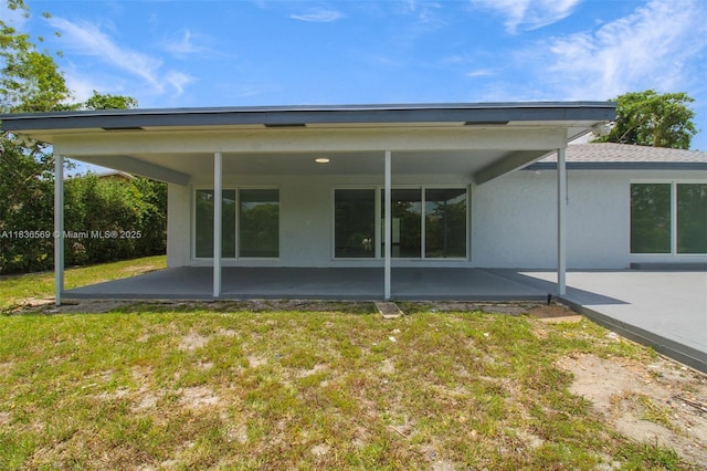 4808 Mango Dr, Tamarac, FL 33319 - rear view of house with a patio, a yard, and stucco siding