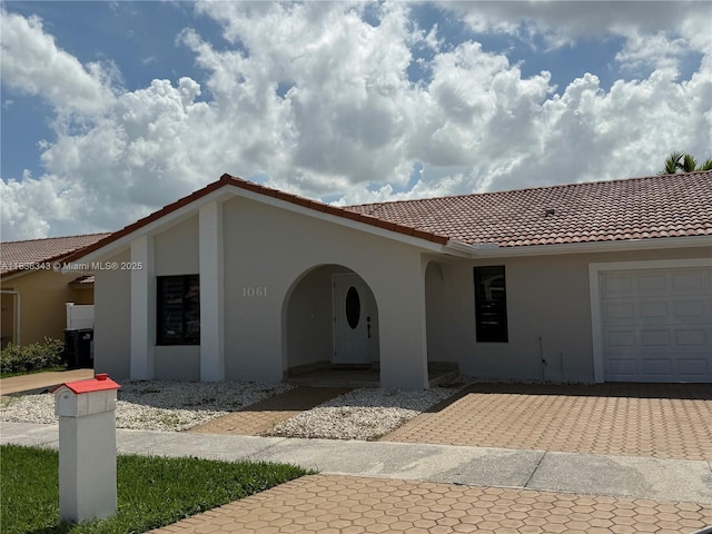 1061 NW 128th Ave, Miami, FL 33182 - view of front of property with stucco siding, driveway, a tile roof, and a garage