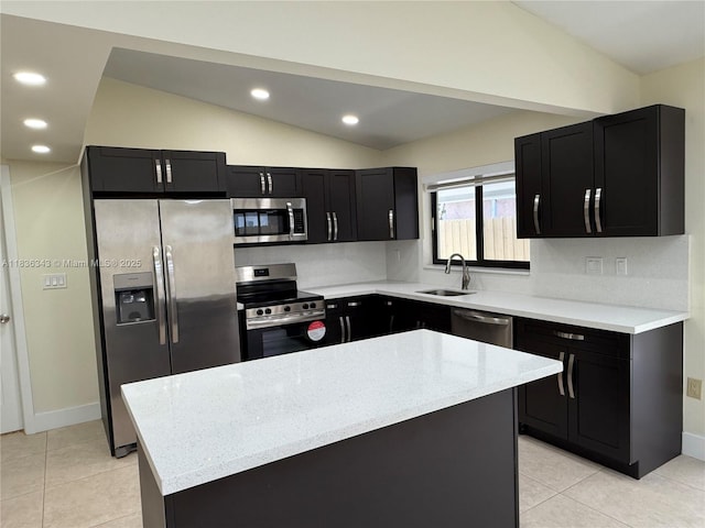 1061 NW 128th Ave, Miami, FL 33182 - kitchen with stainless steel appliances, vaulted ceiling, dark cabinets, light tile patterned floors, and light stone countertops