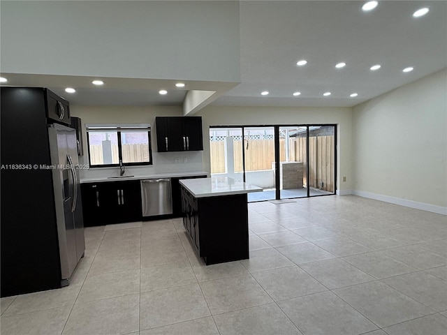 1061 NW 128th Ave, Miami, FL 33182 - kitchen with stainless steel appliances, dark cabinetry, light countertops, recessed lighting, and a kitchen island