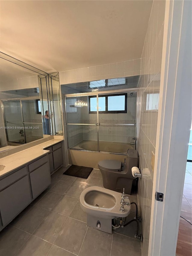 1061 NW 128th Ave, Miami, FL 33182 - bathroom with tile patterned flooring, a bidet, bath / shower combo with glass door, vanity, and tile walls