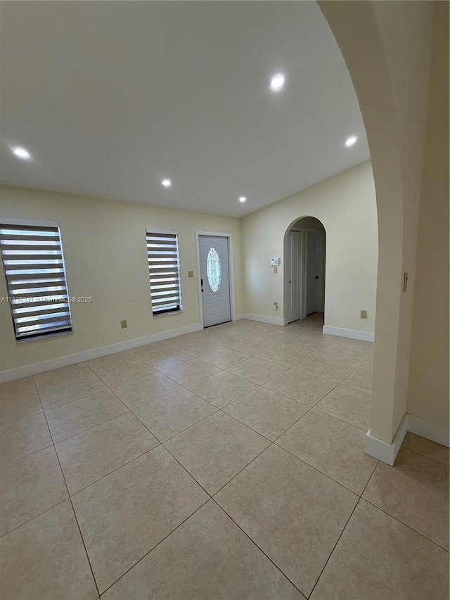 1061 NW 128th Ave, Miami, FL 33182 - empty room with arched walkways, light tile patterned floors, and recessed lighting
