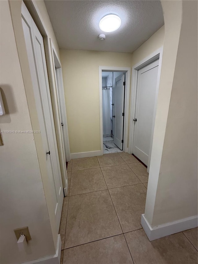 1061 NW 128th Ave, Miami, FL 33182 - hall featuring a textured ceiling and tile patterned flooring