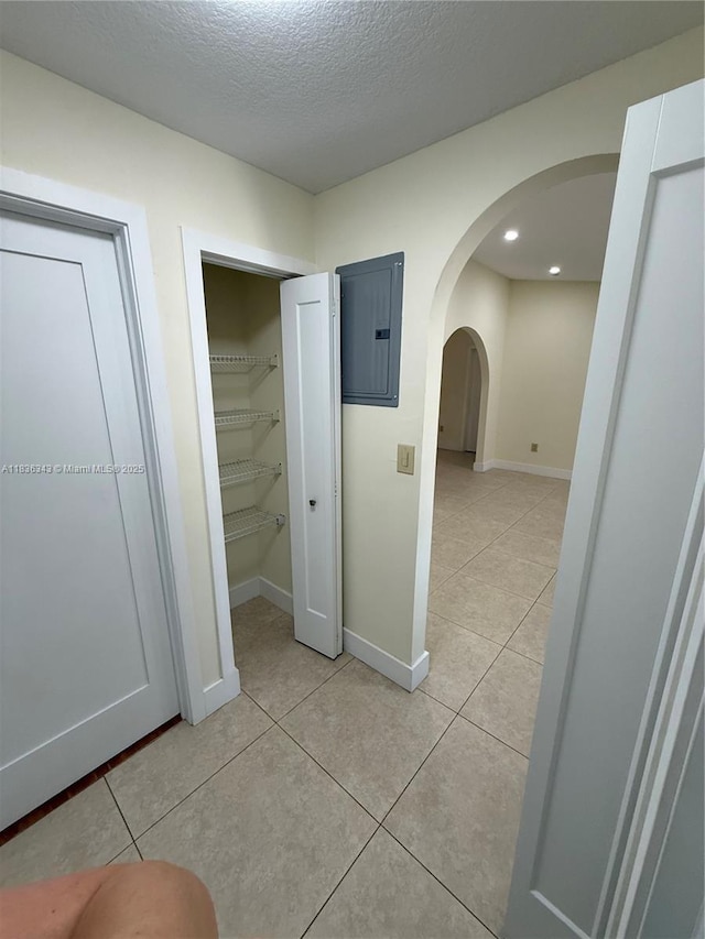 1061 NW 128th Ave, Miami, FL 33182 - hallway featuring electric panel, light tile patterned floors, arched walkways, a textured ceiling, and recessed lighting