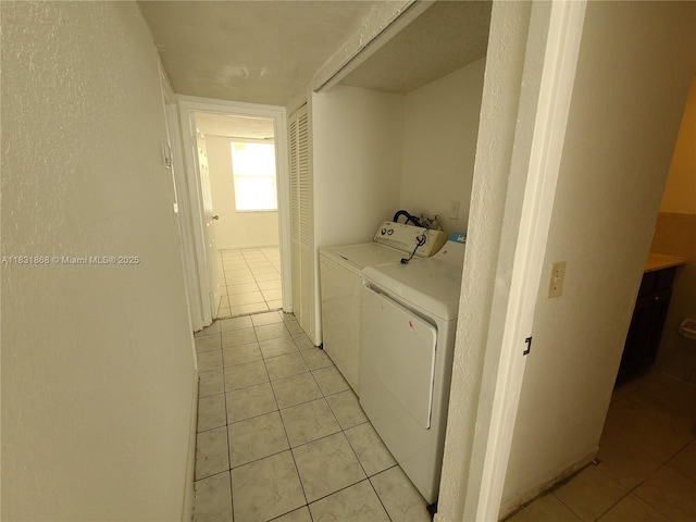 1750 NW 55th Ave Unit 103, Lauderhill, FL 33313 - washroom with separate washer and dryer and light tile patterned floors