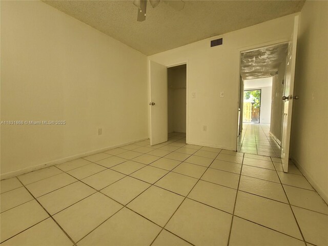 1750 NW 55th Ave Unit 103, Lauderhill, FL 33313 - unfurnished room featuring a textured ceiling, light tile patterned floors, and ceiling fan