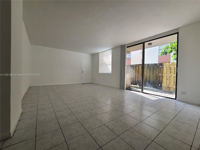 1750 NW 55th Ave Unit 103, Lauderhill, FL 33313 - tiled empty room with healthy amount of natural light and expansive windows