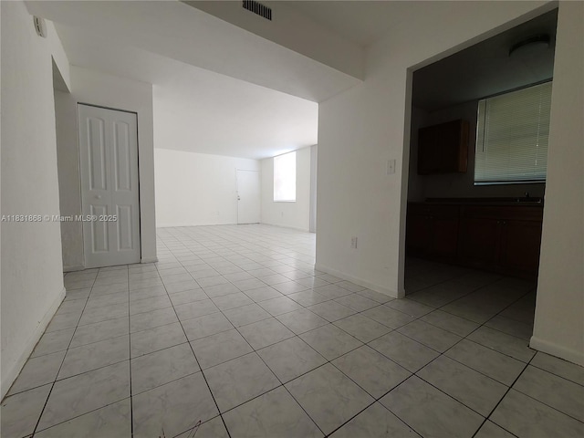 1750 NW 55th Ave Unit 103, Lauderhill, FL 33313 - empty room with light tile patterned flooring and baseboards