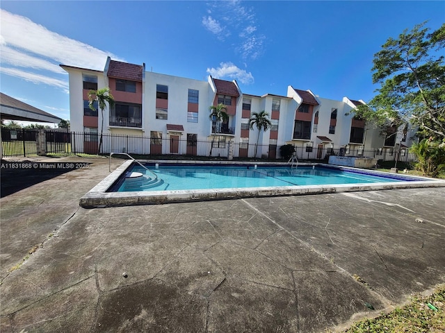 1750 NW 55th Ave Unit 103, Lauderhill, FL 33313 - community pool with a residential view and a patio