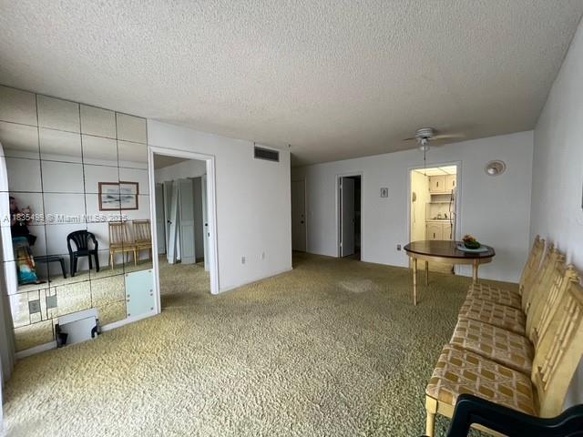 301 Croton Ave Unit 203, Lantana, FL 33462 - living area with a textured ceiling and carpet flooring