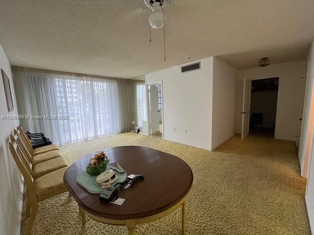 301 Croton Ave Unit 203, Lantana, FL 33462 - carpeted living room with a textured ceiling