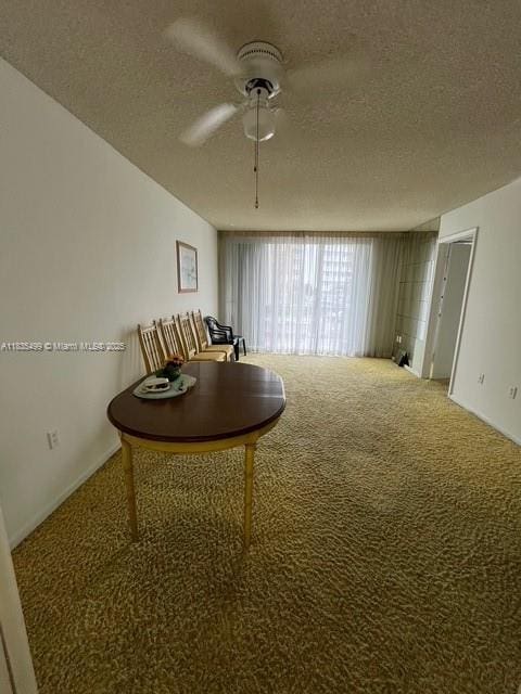 301 Croton Ave Unit 203, Lantana, FL 33462 - dining room with carpet floors, a textured ceiling, and a ceiling fan