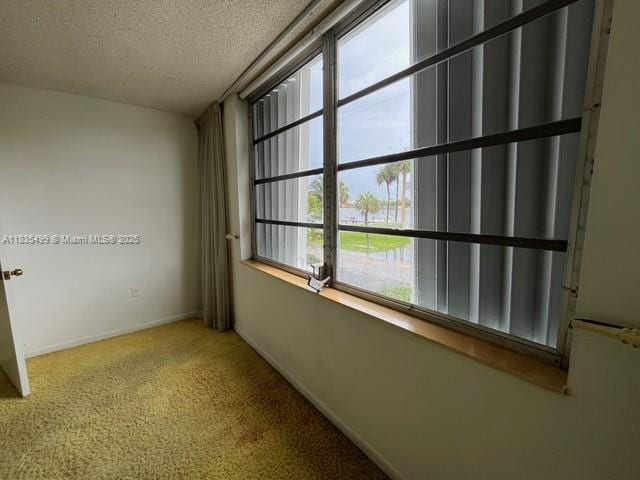 301 Croton Ave Unit 203, Lantana, FL 33462 - carpeted empty room with a textured ceiling and baseboards