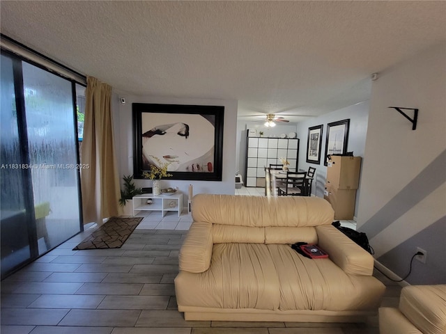 1796 NW 55th Ave Unit 103, Lauderhill, FL 33313 - living area featuring a wall of windows, a ceiling fan, plenty of natural light, and a textured ceiling