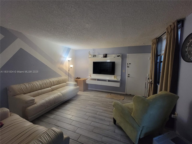 1796 NW 55th Ave Unit 103, Lauderhill, FL 33313 - living room with a textured ceiling and wood finished floors