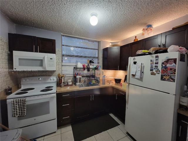 1796 NW 55th Ave Unit 103, Lauderhill, FL 33313 - kitchen featuring white appliances, light countertops, light tile patterned floors, and a textured ceiling