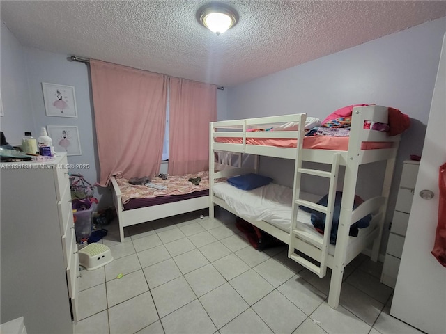 1796 NW 55th Ave Unit 103, Lauderhill, FL 33313 - bedroom with a textured ceiling and light tile patterned flooring