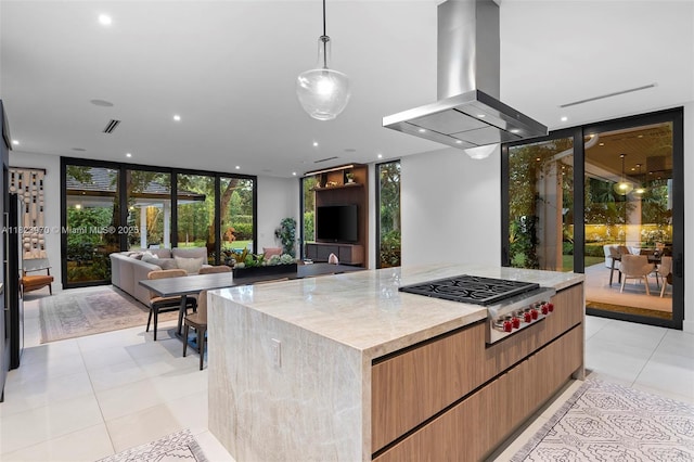 8875 SW 61st Ct, Pinecrest, FL 33156 - kitchen featuring island exhaust hood, stainless steel gas stovetop, a wall of windows, modern cabinets, and light tile patterned flooring