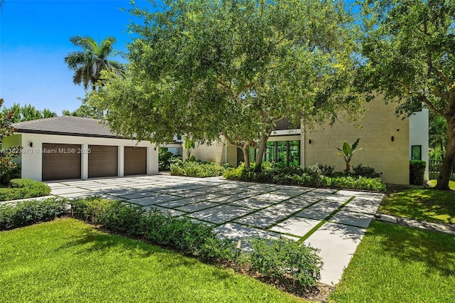 8875 SW 61st Ct, Pinecrest, FL 33156 - surrounding community with driveway, a lawn, and a garage