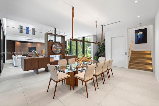 8875 SW 61st Ct, Pinecrest, FL 33156 - dining space featuring stairs, light tile patterned floors, and a wall of windows