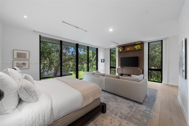 8875 SW 61st Ct, Pinecrest, FL 33156 - bedroom featuring recessed lighting, light wood finished floors, and expansive windows