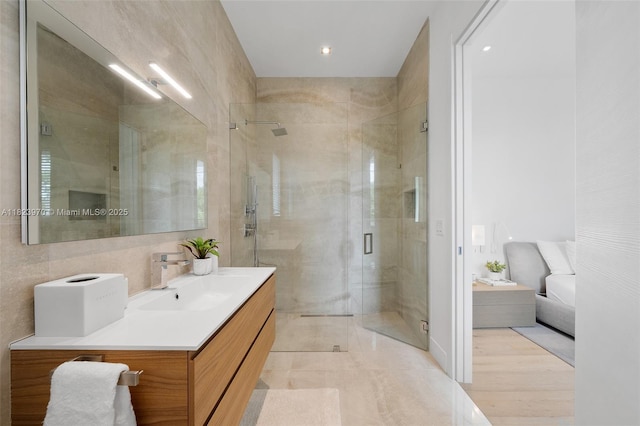 8875 SW 61st Ct, Pinecrest, FL 33156 - bathroom featuring vanity, a shower stall, connected bathroom, and tile walls