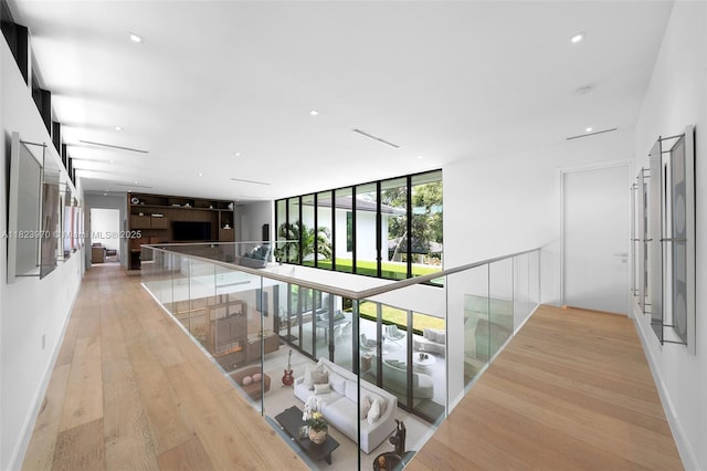 8875 SW 61st Ct, Pinecrest, FL 33156 - corridor with light wood-type flooring, floor to ceiling windows, and recessed lighting