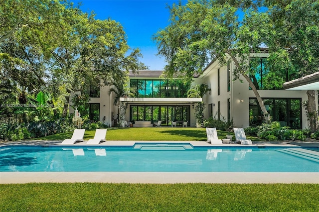 8875 SW 61st Ct, Pinecrest, FL 33156 - rear view of house featuring stucco siding, a lawn, and an outdoor pool