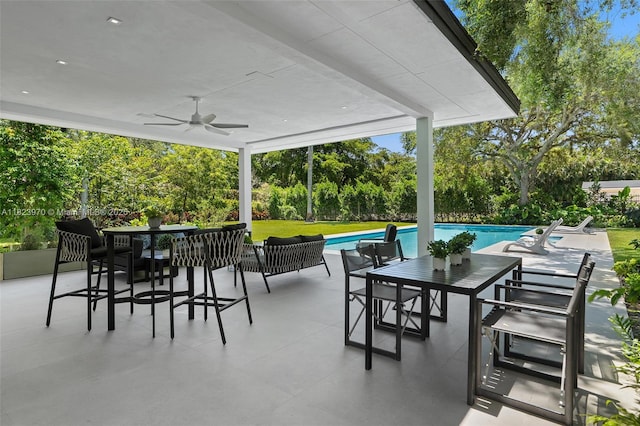 8875 SW 61st Ct, Pinecrest, FL 33156 - view of patio / terrace featuring outdoor dining area, ceiling fan, view of wooded area, and an outdoor pool