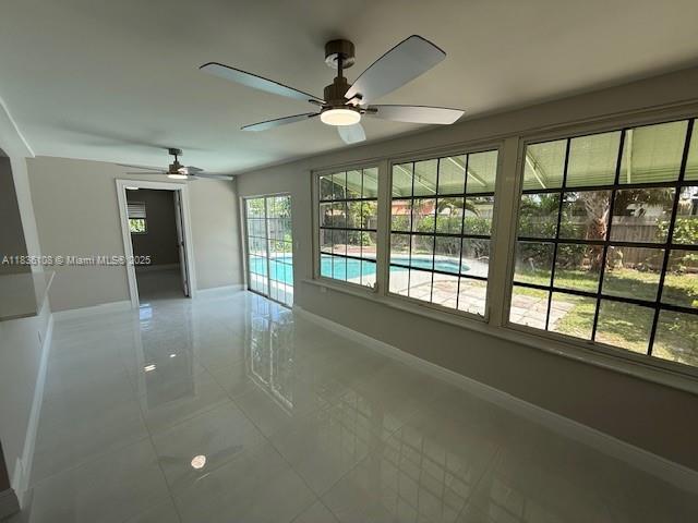 917 SE 15th Ct, Deerfield Beach, FL 33441 - spare room featuring tile patterned floors and a ceiling fan