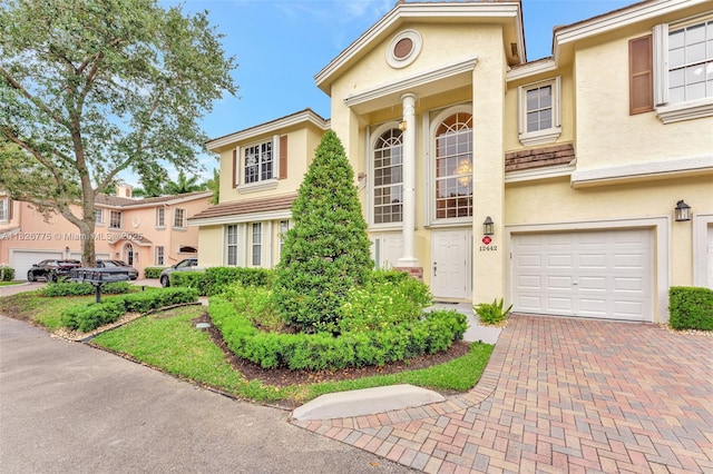 12442 NW 10th Ct Unit C-14, Coral Springs, FL 33071 - view of front of property featuring stucco siding, a garage, and decorative driveway