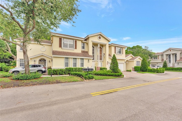 12442 NW 10th Ct Unit C-14, Coral Springs, FL 33071 - view of front facade with stucco siding, driveway, and a tiled roof