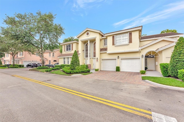 12442 NW 10th Ct Unit C-14, Coral Springs, FL 33071 - view of front of property featuring a garage, decorative driveway, and stucco siding