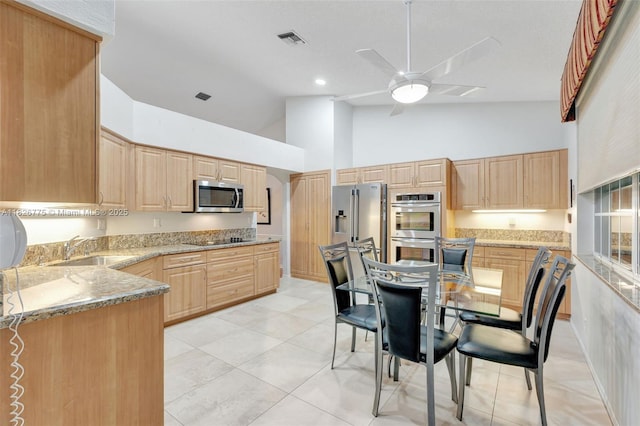 12442 NW 10th Ct Unit C-14, Coral Springs, FL 33071 - kitchen featuring high vaulted ceiling, stainless steel appliances, light brown cabinets, ceiling fan, and light stone counters
