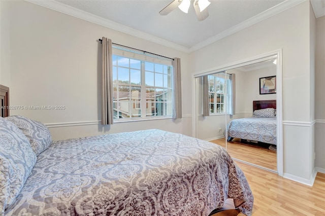 12442 NW 10th Ct Unit C-14, Coral Springs, FL 33071 - bedroom with wood finished floors, ornamental molding, a closet, and ceiling fan