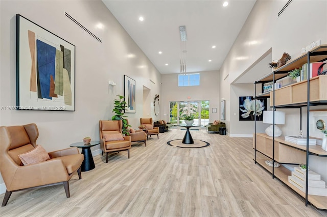 12442 NW 10th Ct Unit C-14, Coral Springs, FL 33071 - living area featuring wood finished floors, a towering ceiling, and recessed lighting