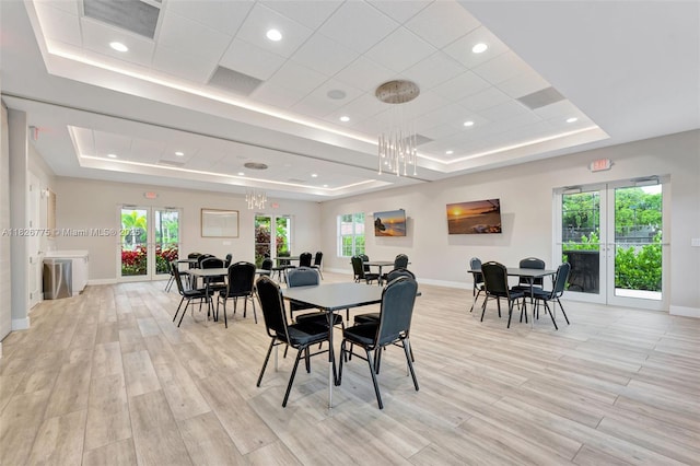 12442 NW 10th Ct Unit C-14, Coral Springs, FL 33071 - dining area with a raised ceiling, a chandelier, light wood-type flooring, healthy amount of natural light, and recessed lighting