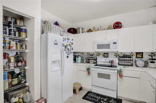 4292 SW 156th Ave Unit 154, Miramar, FL 33027 - kitchen with white appliances, light countertops, white cabinets, and light tile patterned floors
