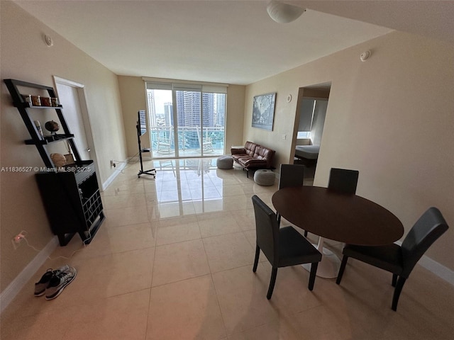 951 Brickell Ave Unit 2405, Miami, FL 33131 - dining room with a wall of windows and light tile patterned flooring
