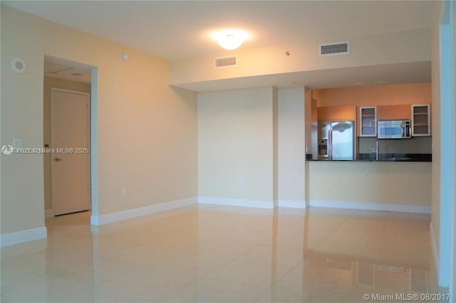951 Brickell Ave Unit 2405, Miami, FL 33131 - spare room with light tile patterned floors and baseboards