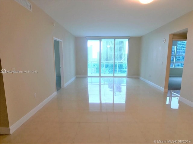 951 Brickell Ave Unit 2405, Miami, FL 33131 - empty room featuring light tile patterned flooring and baseboards