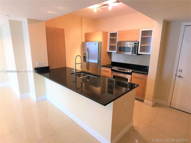 951 Brickell Ave Unit 2405, Miami, FL 33131 - kitchen with appliances with stainless steel finishes, a peninsula, light tile patterned floors, dark countertops, and glass insert cabinets
