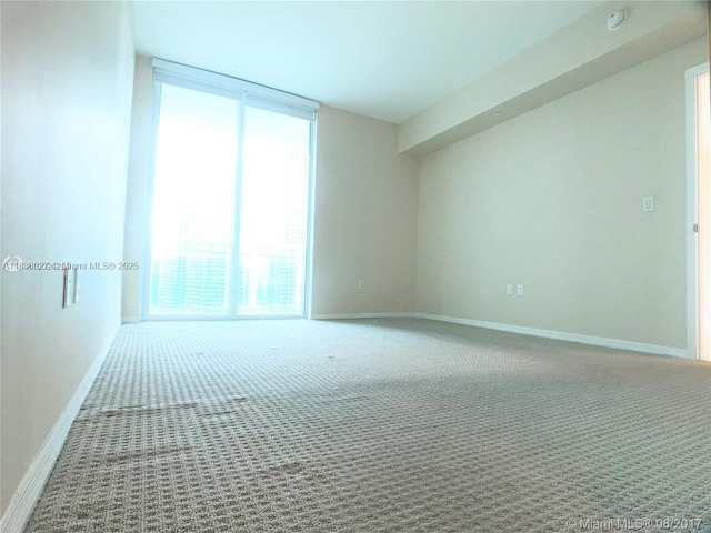 951 Brickell Ave Unit 2405, Miami, FL 33131 - carpeted empty room with baseboards and a smoke detector