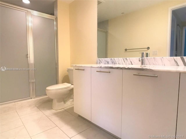 951 Brickell Ave Unit 2405, Miami, FL 33131 - bathroom with vanity, a stall shower, tile patterned floors, and recessed lighting