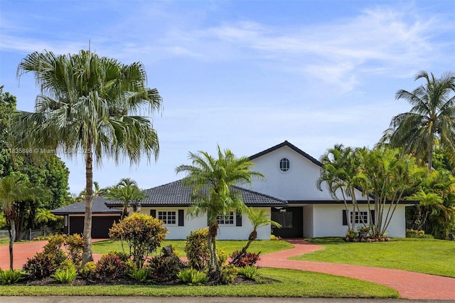11965 SW 15th Ct, Davie, FL 33325 - single story home featuring stucco siding, driveway, a front lawn, and an attached garage