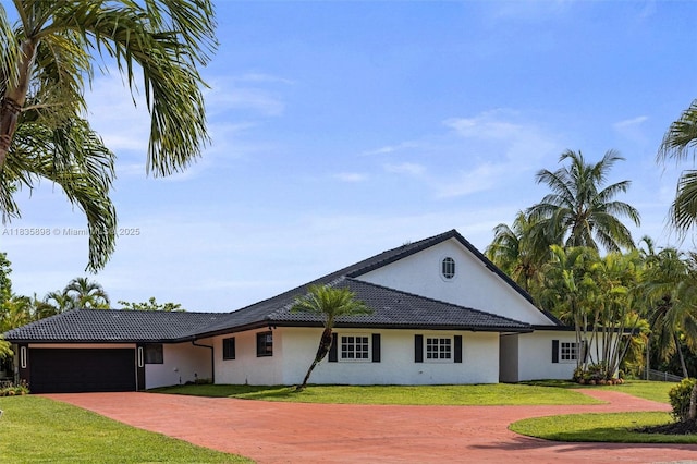 11965 SW 15th Ct, Davie, FL 33325 - view of front of house featuring decorative driveway, stucco siding, a front yard, and an attached garage